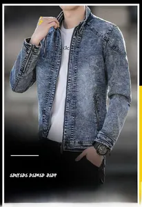 Detail of blue washed denim jacket with stand collar and zipper pockets for men