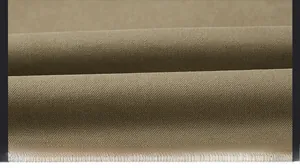Detailed macro view of heavy khaki twill fabric texture for warm winter jacket