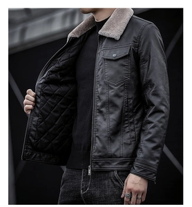 Detail of men's black leather biker jacket showing beige faux fur collar and quilted lining