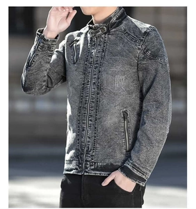 Detail of grey denim jacket featuring stand collar and metal zipper pockets on front