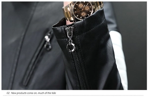 Detail of black faux leather jacket cuff featuring a silver ring zipper and sleek texture