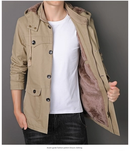 Detail of winter khaki parka featuring thick brown fleece lining and hooded design