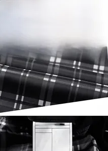 Detail of marble pattern button and black-grey-white plaid lining on polyester jacket