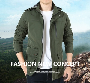 Detail of army green outdoor jacket featuring plaid lining and tactical utility pockets