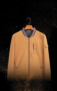Close-up of khaki reversible jacket with striped stand collar and functional pockets