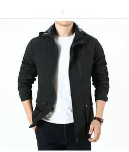 Detail of men's hooded windbreaker with utility pockets and contrast plaid collar detail