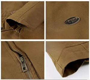 Detailed macro view of khaki canvas jacket showing twill texture, brass zipper and cuffs