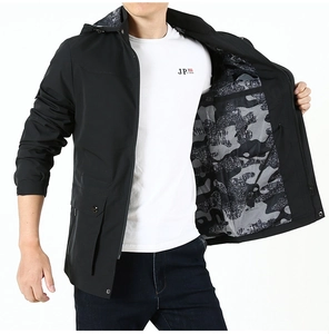 Detail of men's black hooded jacket with stylish camo lining and large flap pockets