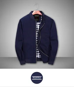 Detail of royal blue bomber jacket with checkered lining and ribbed standing collar