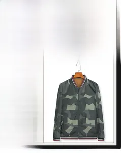 Close-up of camouflage reversible bomber jacket showing ribbed cuffs and zipper detail