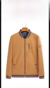 Detailed front view of mustard yellow reversible bomber jacket with striped ribbed cuffs