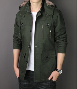 Detail of dark green winter parka with faux fur hood lining and durable canvas texture