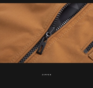 Close-up of durable black resin zipper and stitching on brown wash jacket