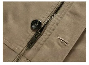 Detailed macro view of high-quality metal zipper and resin button on khaki windbreaker jacket