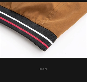 Detailed close-up of brown jacket rib knit cuff with red and white striped accents