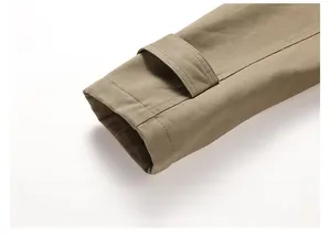Detail of adjustable khaki cotton jacket cuff with precision stitching and twill texture