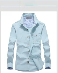 Detail view of light blue shirt collar with navy paisley pattern lining and buttons