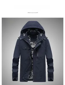 Detail of dark blue outdoor jacket featuring metal zipper and camo printed inner lining