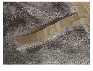 Detail of winter jacket with thick grey fleece lining and secure khaki interior pocket
