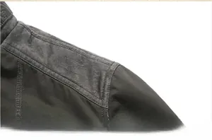 Detailed view of heavy-duty reinforced shoulder stitching on men's winter jacket