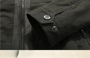 Detail view of durable outdoor jacket cuff with metal snap buttons and heavy stitching