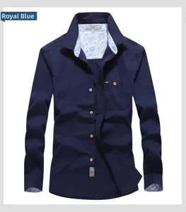 Detail of royal blue men's shirt showing paisley lining on collar and cuffs with chest pocket