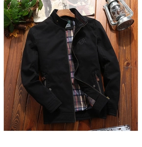 Detail of men's black stand collar jacket with tartan lining and chest embroidery