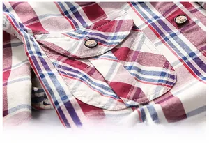 Close-up of a plaid cotton shirt featuring a red and navy blue pocket with a button