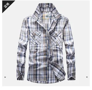 Close-up detail of blue plaid long sleeve shirt with classic collar and double chest pockets