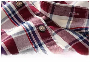 Close-up of red and blue plaid cotton fabric with embossed button detailing
