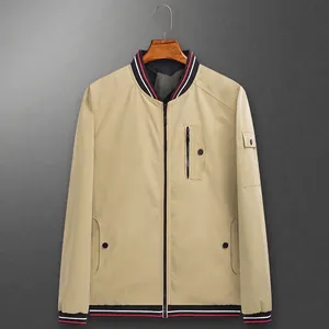 Men's reversible khaki bomber jacket with striped ribbed trims and functional pockets