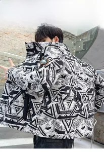 Detail view of winter puffer jacket featuring black and white graffiti print and sleeve patch