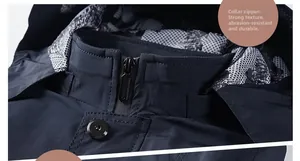 Detail of hooded windbreaker featuring a waterproof zipper, metal button and plaid lining