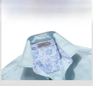 Detail of light blue shirt collar with exquisite blue paisley pattern lining inside