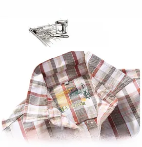 Detail shot of men's plaid shirt collar with a classic check pattern in brown and beige