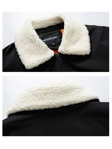 Detail of black cotton jacket featuring a cream faux shearling collar and branded inner label