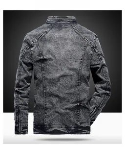 Detail view showing back panel seams and zipper cuffs of a black washed denim jacket