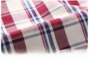 Detailed view of red, white, and blue plaid cotton fabric with soft twill weave texture