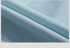 Close-up of light blue cotton fabric texture with neat stitching and smooth weave