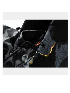 Detail of camo parka featuring orange accents and golden foil texture on hood