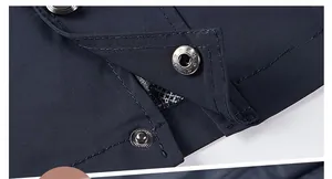 Detail view of durable snap button and double stitching on men's windbreaker jacket