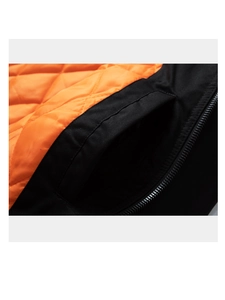 Close-up of diamond-quilted orange lining and durable black exterior fabric