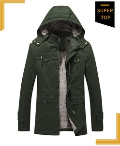 Detail view of dark green winter jacket showing warm gray fleece lining and canvas fabric