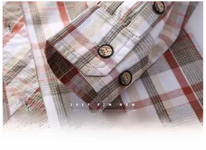 Detailed macro view of vintage plaid shirt cuffs with wood-grain buttons and fine stitching