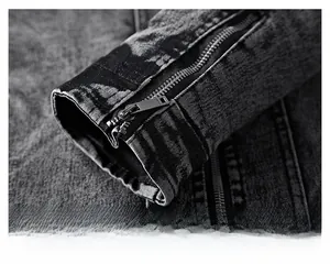 Close-up detail of vintage dark wash denim cuff featuring a rugged metal zipper closure