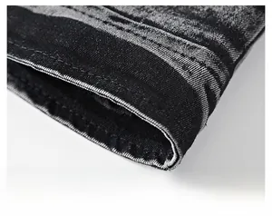Macro shot showing high-quality denim fabric texture and neat stitching on jacket hem