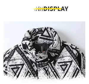 Detail view of winter puffer jacket stand collar with black and white geometric print