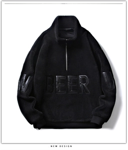Détail du sweat en laine d'agneau noire avec patch cuir BEER et demi-zip argenté