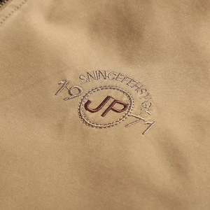 Men's khaki stand collar jacket featuring detailed embroidery and twill texture fabric