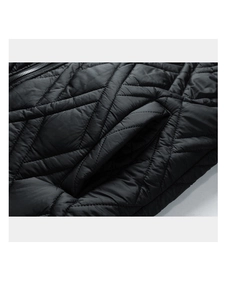 Detail of black quilted fabric with diamond stitching and side pocket on winter coat